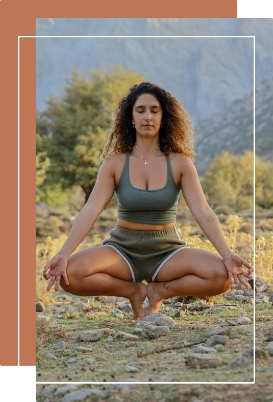 a woman meditating outdoors